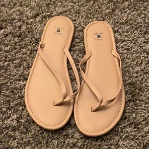 Tan flip flops